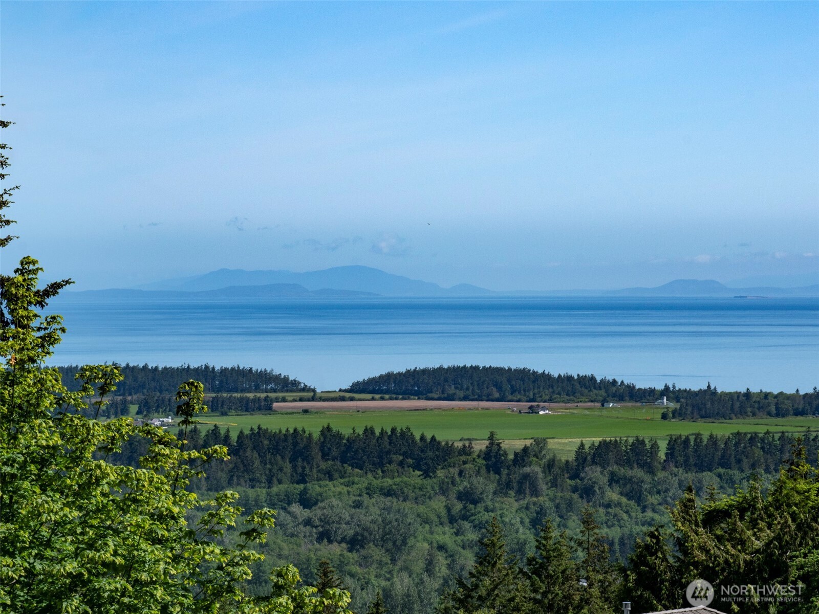 -nka Owls Nest Road Sequim, WA 98382 - Photo 28 of 38 a view of a field with ocean and trees