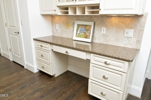 a kitchen with granite countertop white cabinets and white appliances