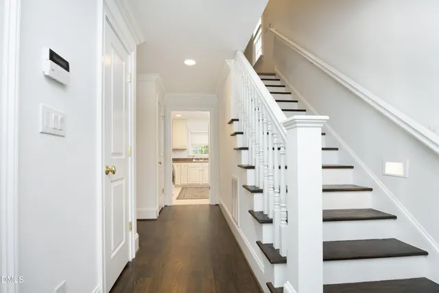 a view of a hallway with wooden floor and entryway