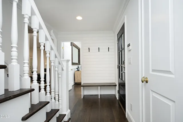 a view of a hallway with wooden floor and staircase