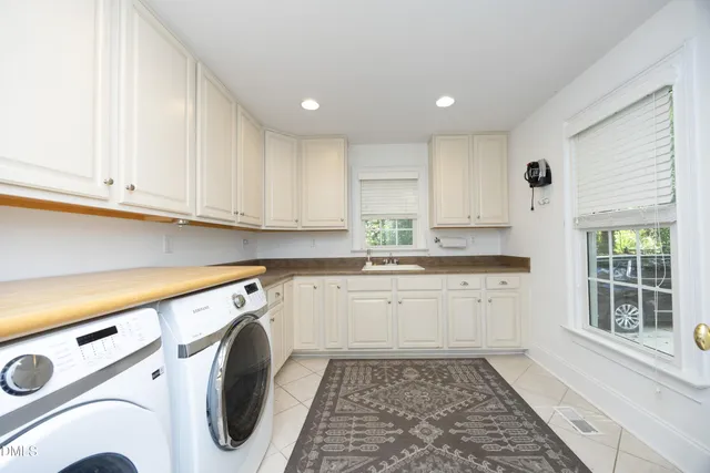 a kitchen with a sink a stove and cabinets