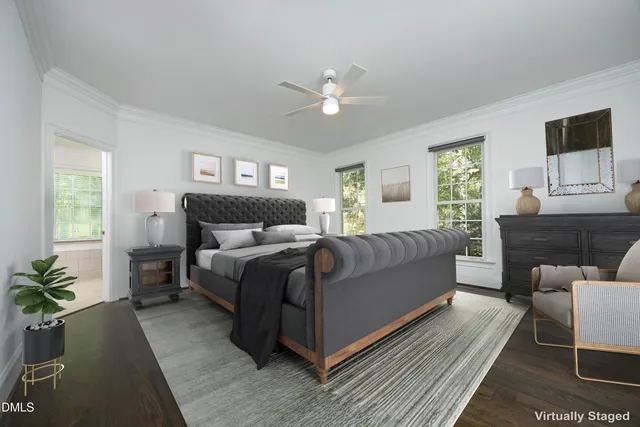 a bedroom with a large bed couch and windows