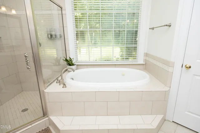 a white bath tub sitting next to a shower