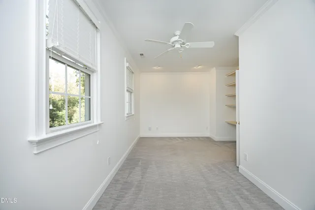 an empty room with windows and closet