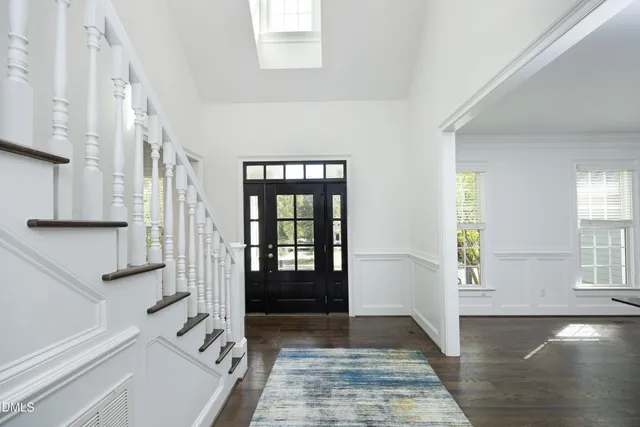 a view of an entryway with wooden floor and a livingroom