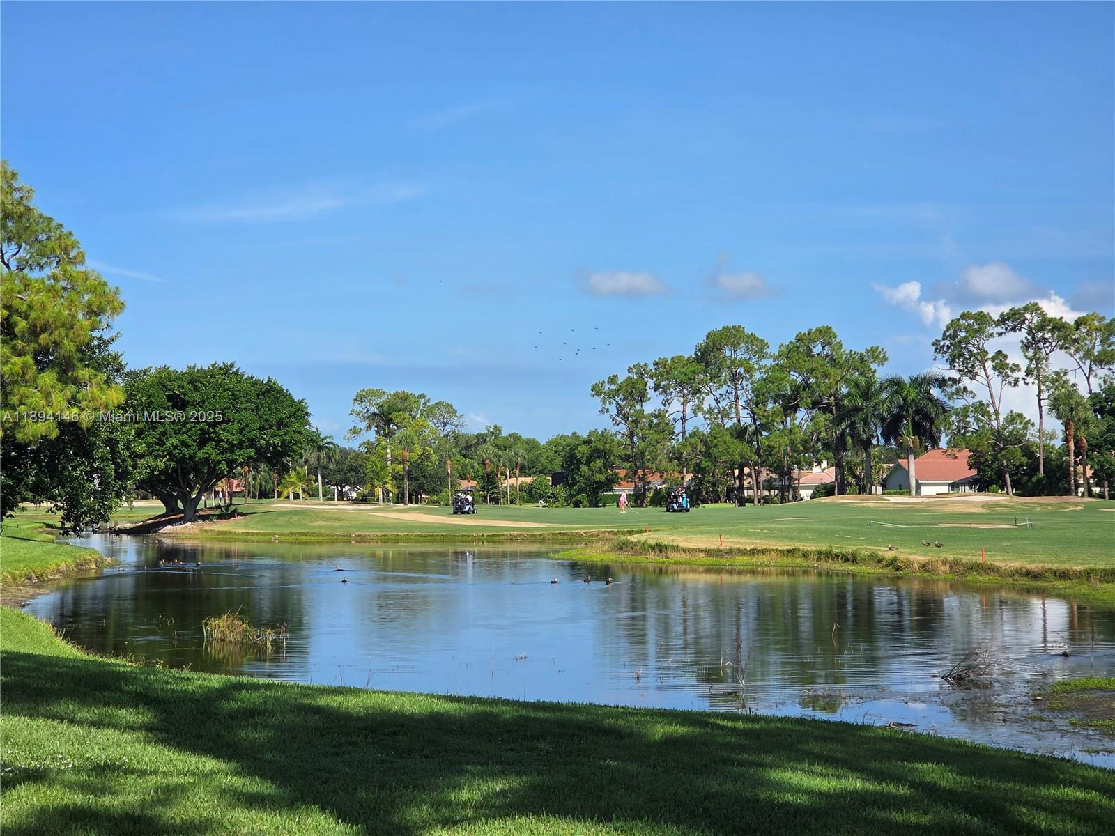 a view of a lake with a house in the background