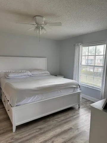 a spacious bedroom with a bed and a window
