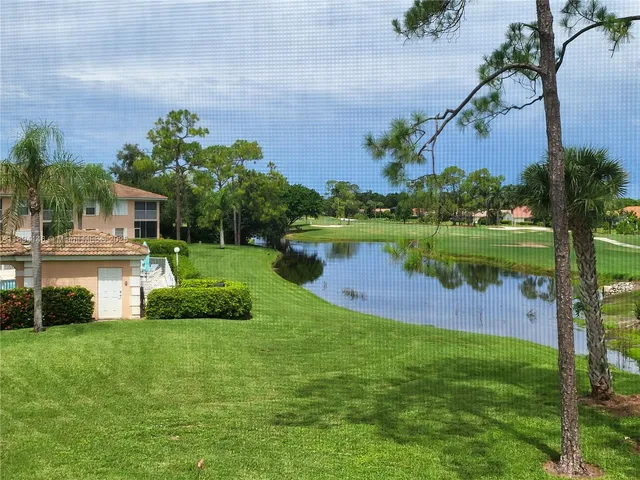 a view of a house with a yard and a fountain