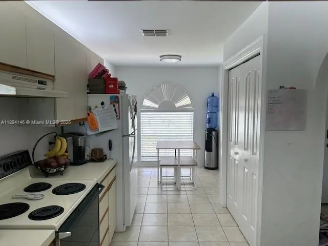 a kitchen with sink cabinets and appliances