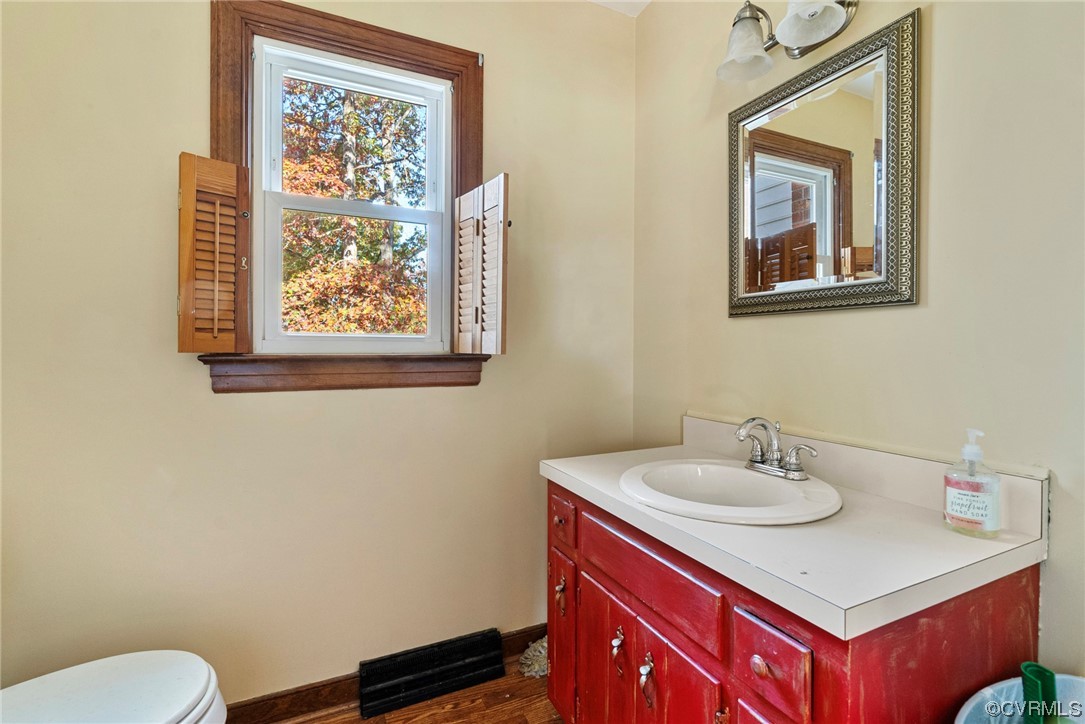 3319 Ludgate Road Chester, VA 23831 - Photo 20 of 47 a bathroom with a sink mirror and a toilet