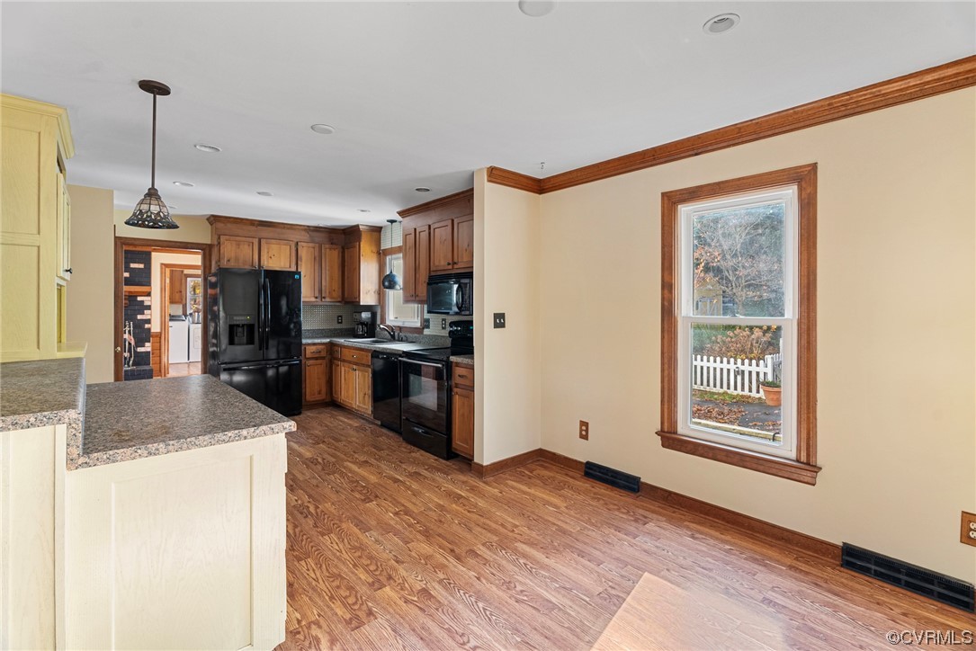 3319 Ludgate Road Chester, VA 23831 - Photo 9 of 47 a kitchen with stainless steel appliances granite countertop a refrigerator a oven a sink with wooden floors and cabinets