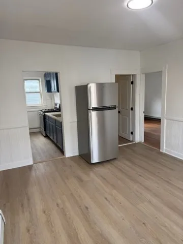 a kitchen with a refrigerator and a stove top oven