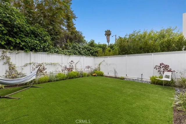 a view of a backyard with plants and a lake