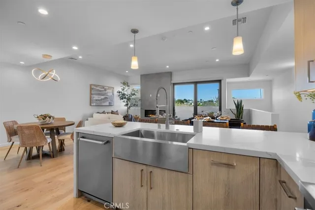 a kitchen with center island a sink stainless steel appliances and cabinets