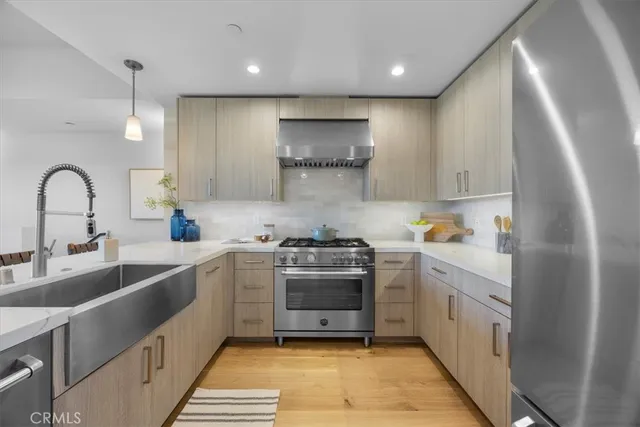 a kitchen with a sink stainless steel appliances and cabinets