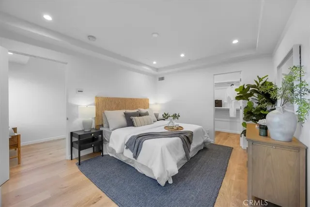 a bedroom with bed and a potted plant