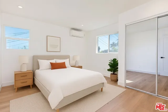 a bedroom with a bed and a potted plant