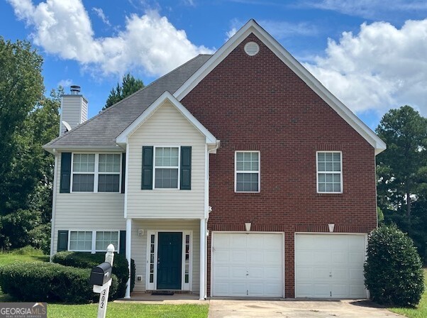 303 Millstone Drive Hampton, GA 30228 - Photo 1 of 1 a front view of a house with garden