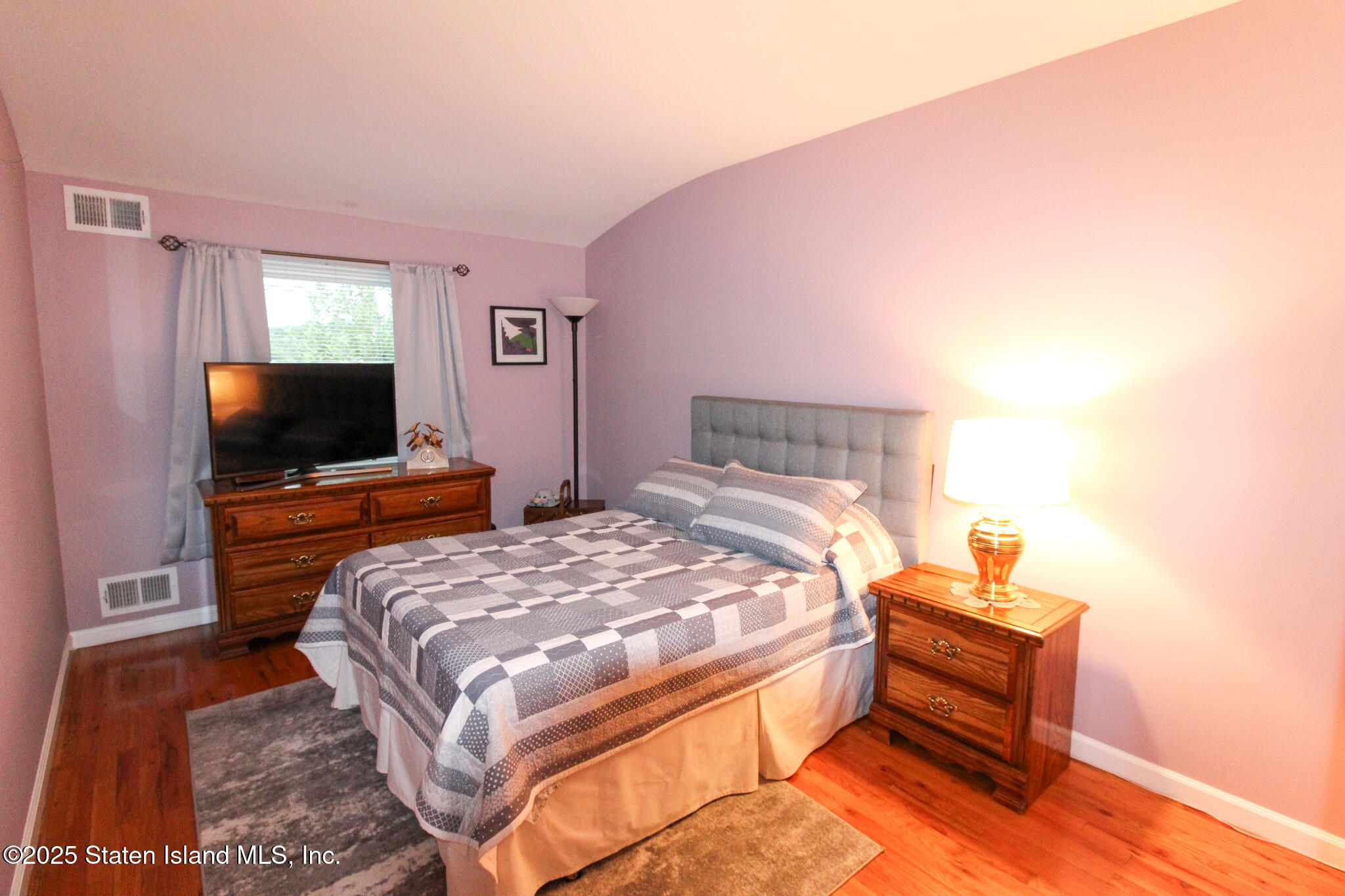 135 Freedom Avenue Staten Island, NY 10314 - Photo 12 of 29 a bedroom with a bed and a flat screen tv