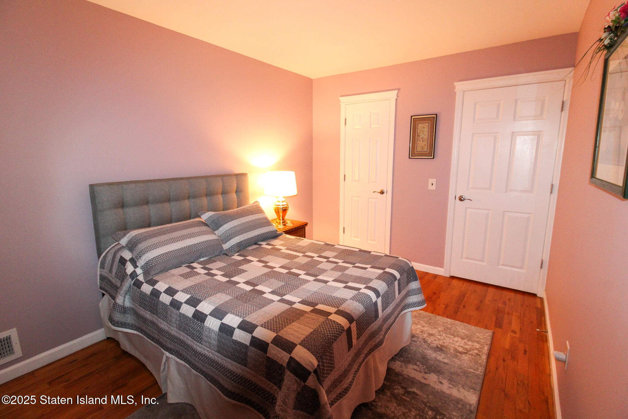 135 Freedom Avenue Staten Island, NY 10314 - Photo 13 of 29 a bed sitting in a bedroom next to a window