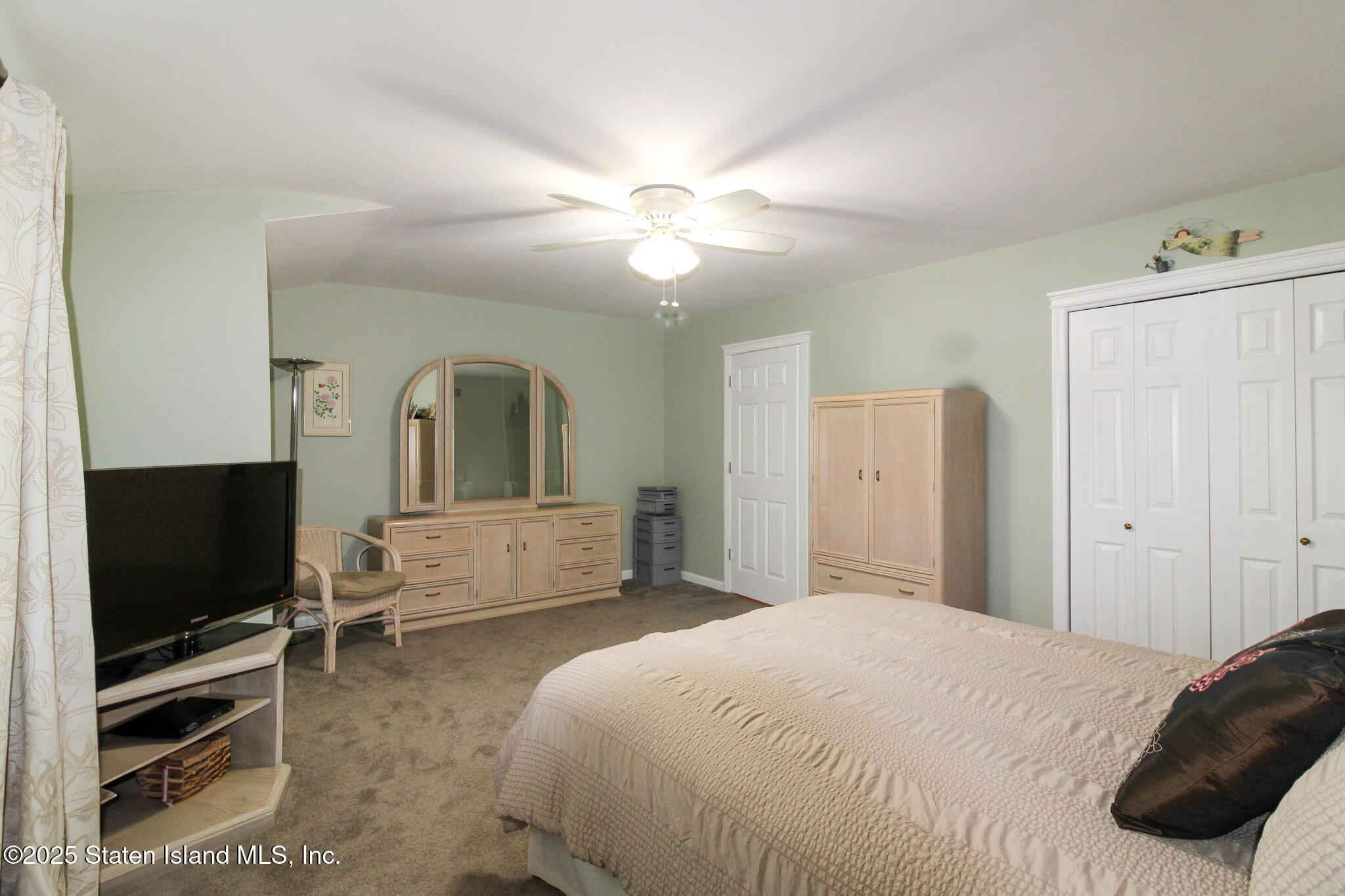 135 Freedom Avenue Staten Island, NY 10314 - Photo 16 of 29 a bedroom with a bed and a flat screen tv