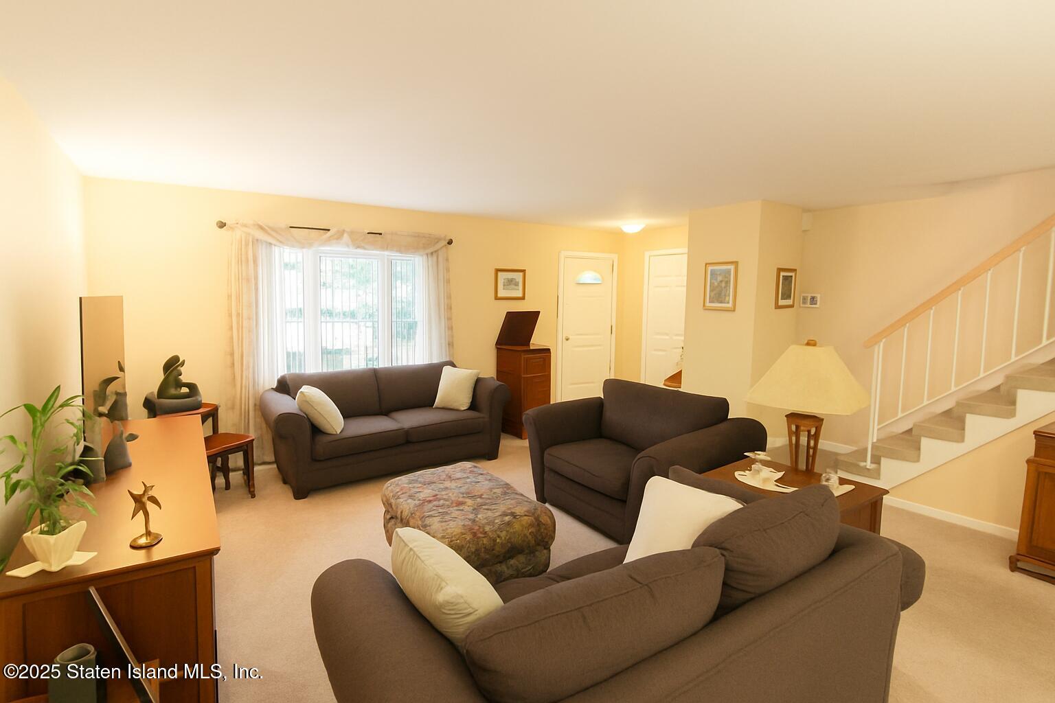 135 Freedom Avenue Staten Island, NY 10314 - Photo 2 of 29 a living room with furniture and a large window