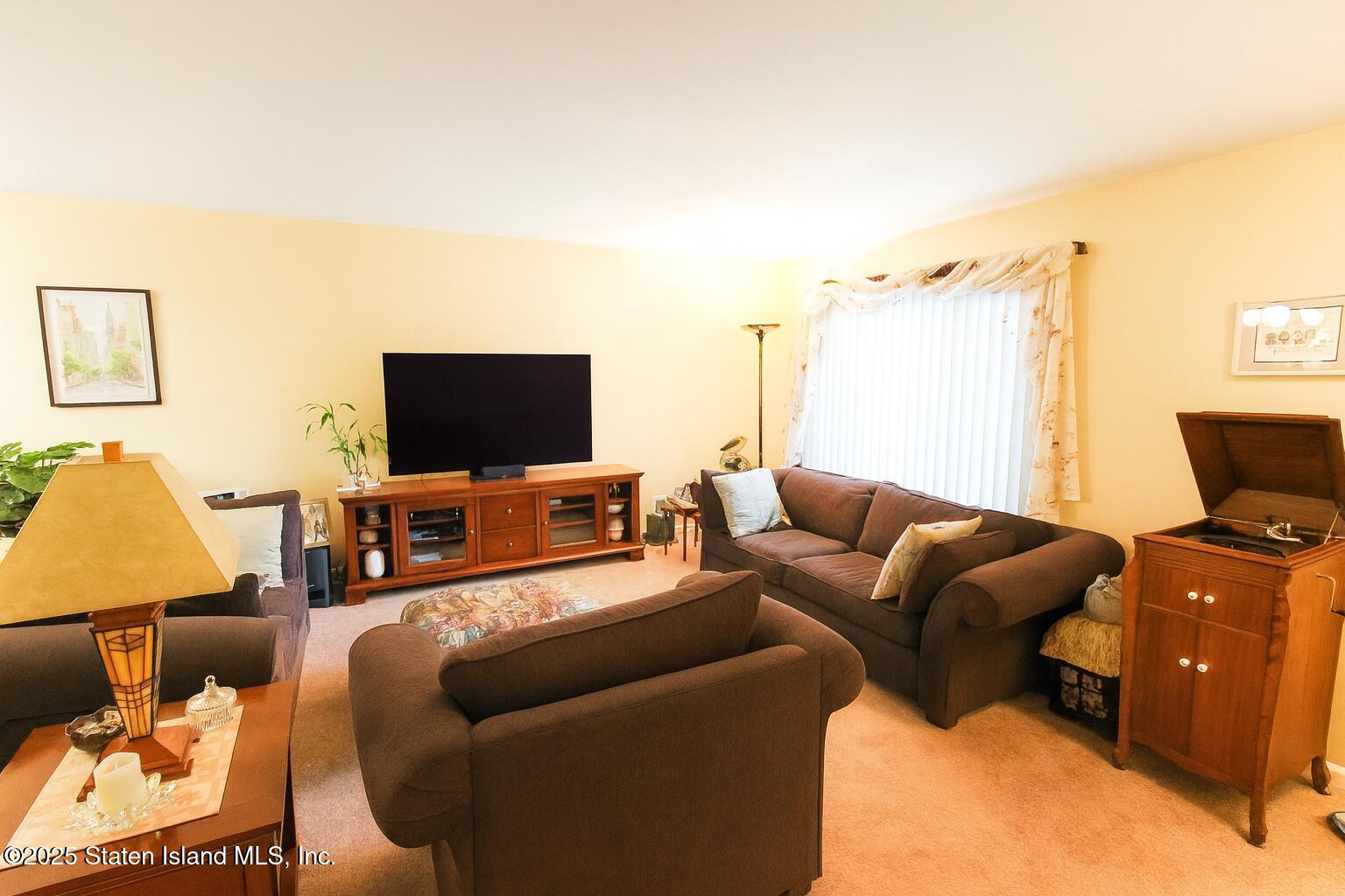 135 Freedom Avenue Staten Island, NY 10314 - Photo 3 of 29 a living room with furniture and a flat screen tv