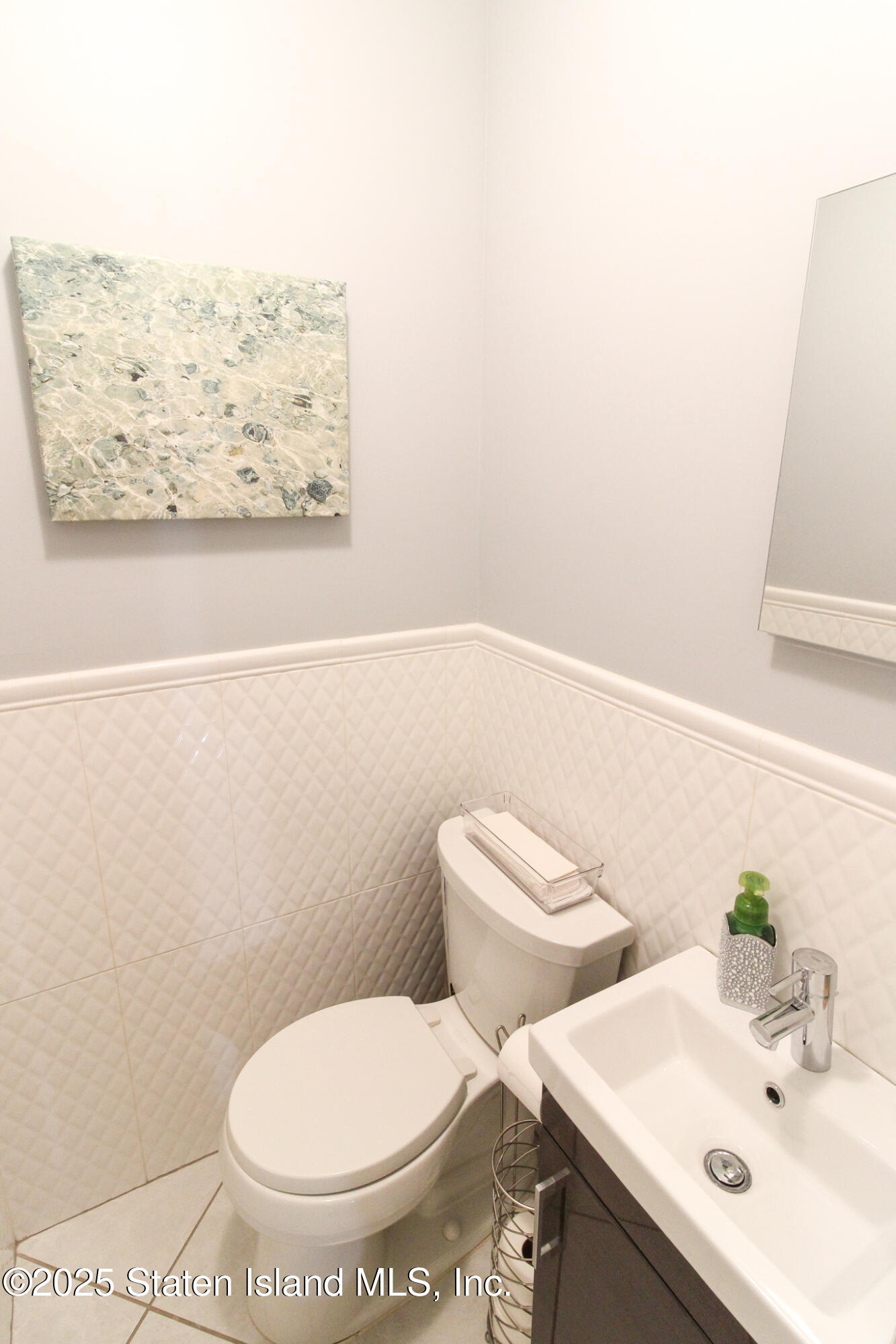 135 Freedom Avenue Staten Island, NY 10314 - Photo 9 of 29 a white toilet sitting next to a bathroom sink