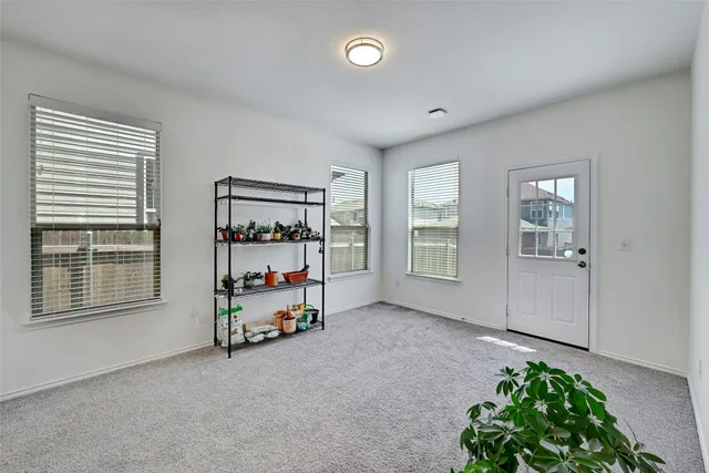 an empty room with furniture and window