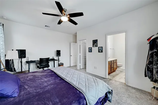 a bathroom with a sink vanity granite toilet and a mirror