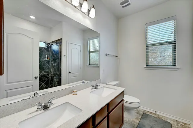 a bathroom with a glass shower door
