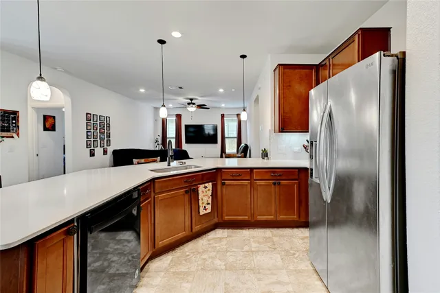 a large kitchen with kitchen island a sink stainless steel appliances and cabinets