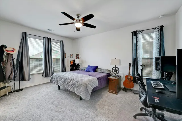 a bedroom with bed and a chandelier