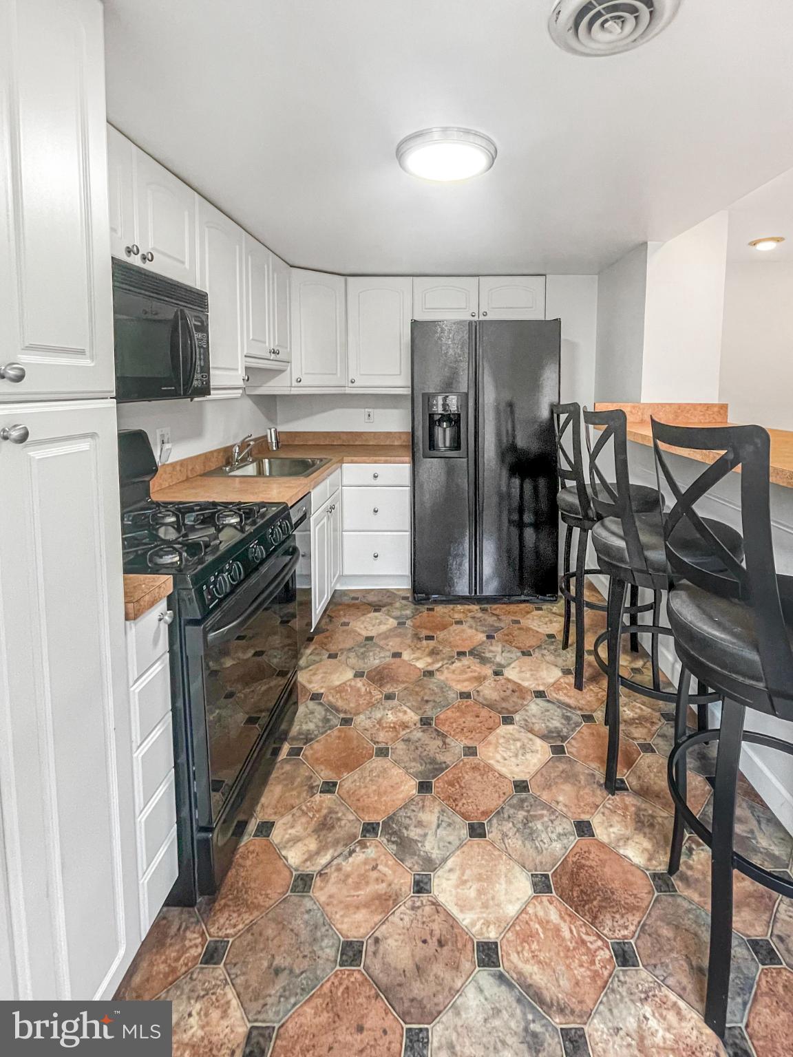 1436 Light Street Baltimore, MD 21230 - Photo 18 of 21 Modern kitchen with stylish tile flooring.