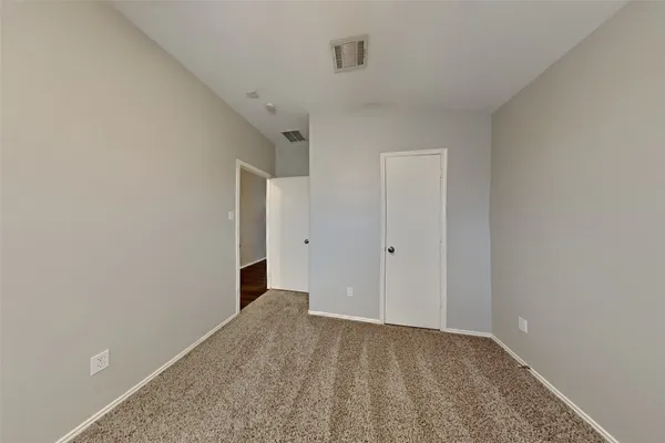 a view of a big room with closet and windows