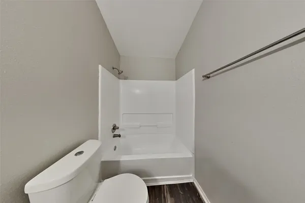 a bathroom with a toilet and a bath tub