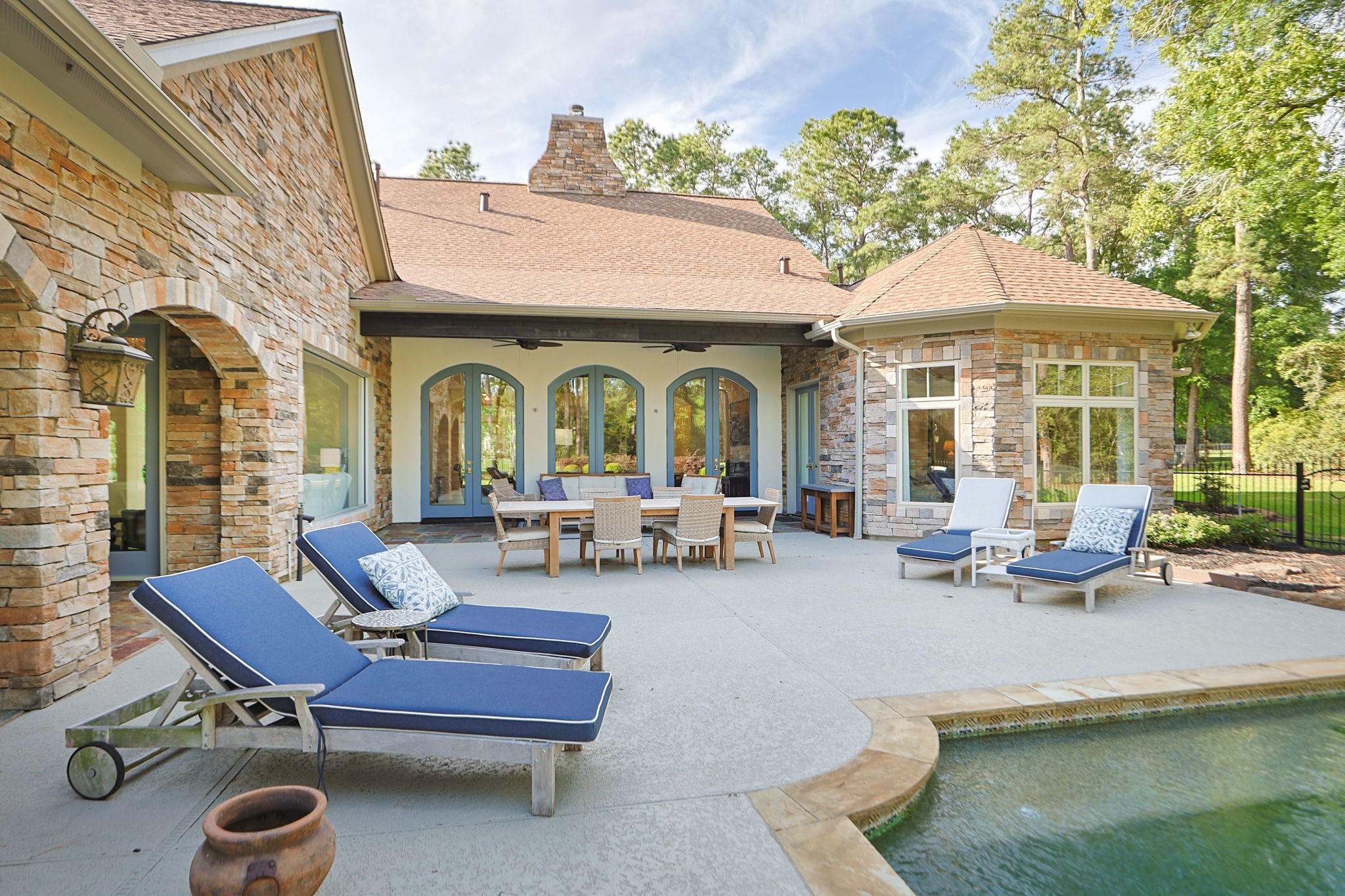38223 Windy Ridge Trail Magnolia, TX 77355 - Photo 35 of 48 This photo showcases a spacious, elegant backyard patio with stone accents, featuring a pool, and plenty of space for your outdoor furniture.