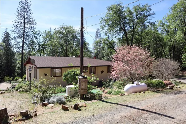 a front view of a house with a yard and sitting area
