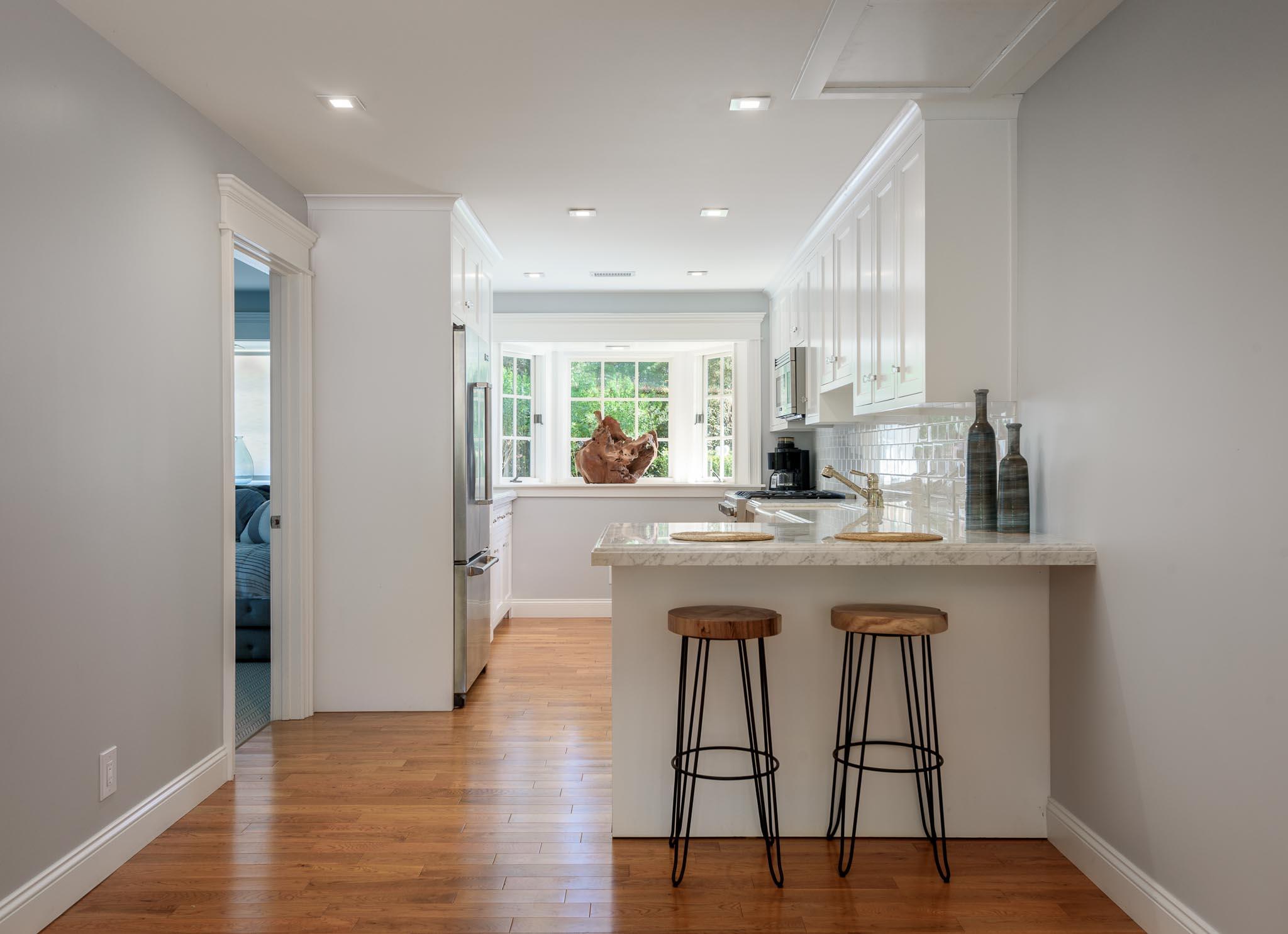 167 Pomar Lane Montecito, CA 93108 - Photo 23 of 35 a kitchen with stainless steel appliances granite countertop a sink and a wooden floor