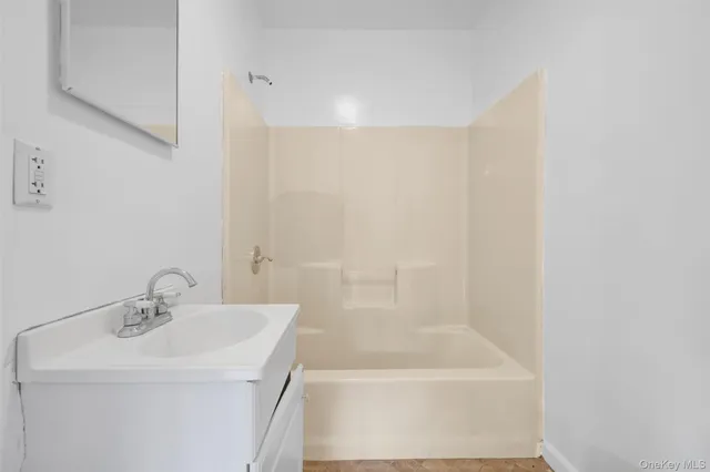 a bathroom with a bathtub and a sink