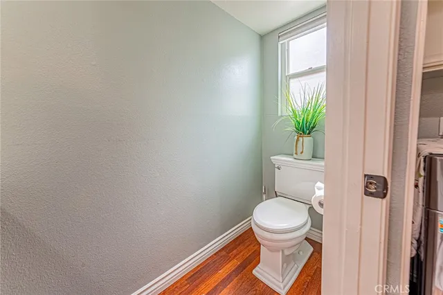 a white toilet sitting next to a window