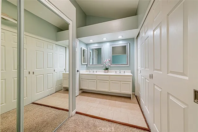 a bathroom with a sink a mirror and a shower