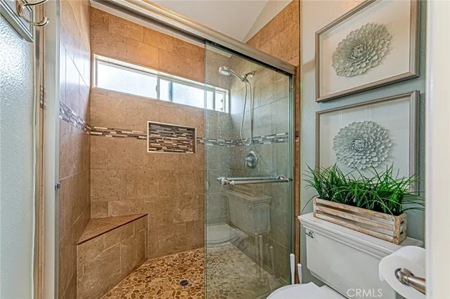 a bathroom with a shower and a toilet