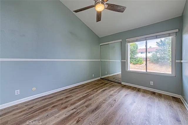 wooden floor in an empty room with a window