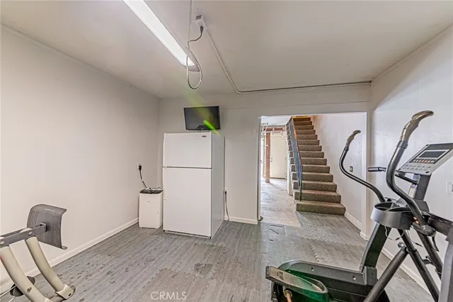 a view of a livingroom with wooden floor and a hallway