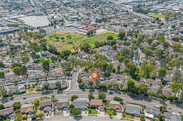an aerial view of residential houses with outdoor space