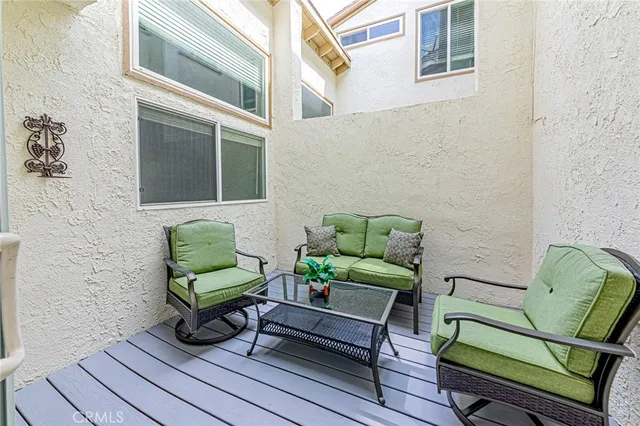 a view of a two chairs in the balcony