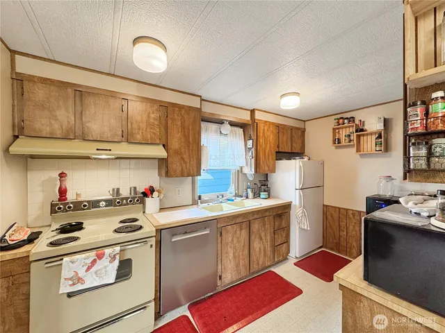 a kitchen with a stove and a refrigerator