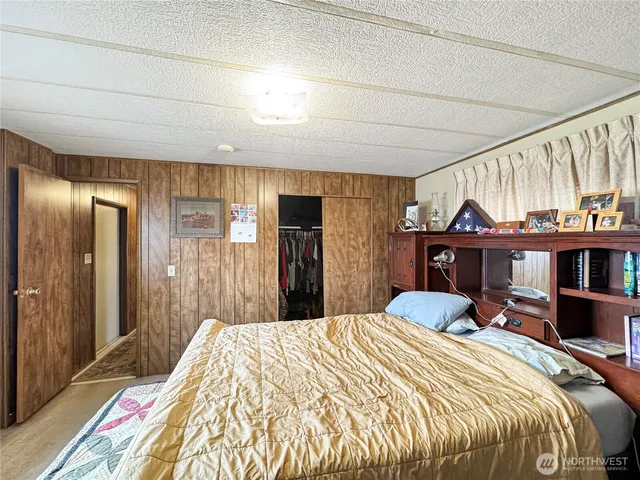 a bedroom with a bed and a book shelf