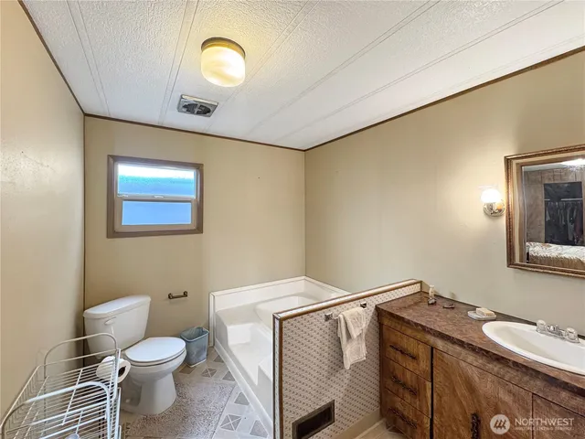a bathroom with a toilet sink and mirror